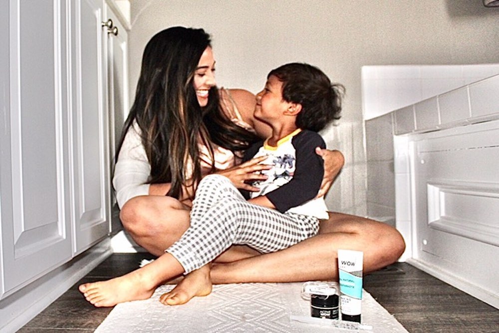 Young mother hugging her son with Active Wow products near them